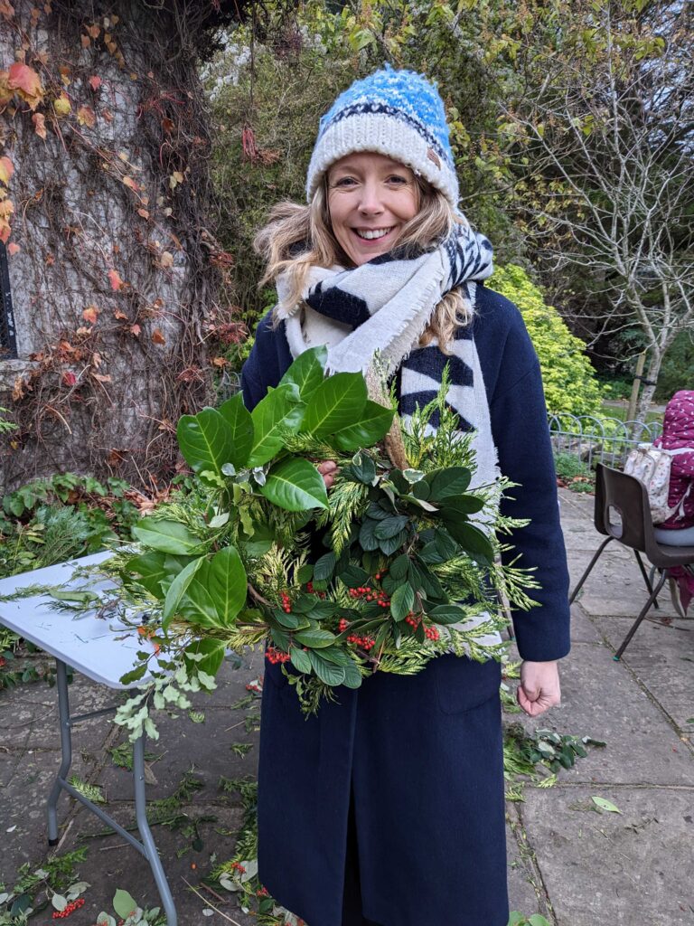 one lady holding a christmas wreath